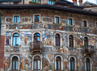 Trento, Italy, June 2021. The facade of Cazuffi-Rella houses in Duomo square, a finely frescoed historic building in the center.