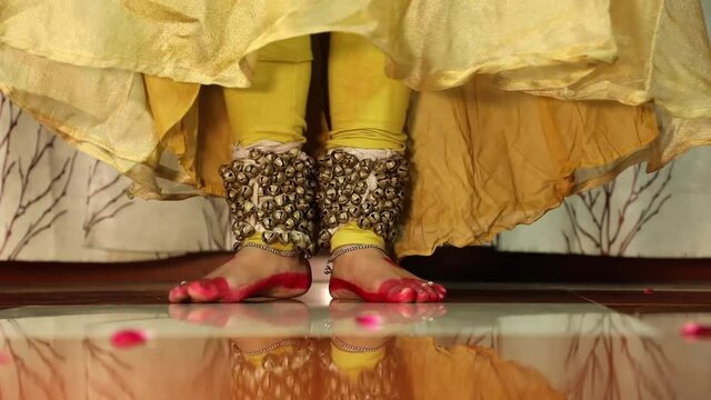 Indian Classical Kathak Female Girl Lady Dancer FootWork In Red Costume With Ghungroo Ghungru Or Noopura Which Is A Musical Anklet To Tie On The Feet Painted With Alta Red Dye Altha Aalh Or Mahavar