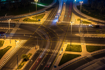 Cross road junction with light trails from cars. Street