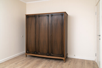 Old wooden wardrobe in a renovated living room