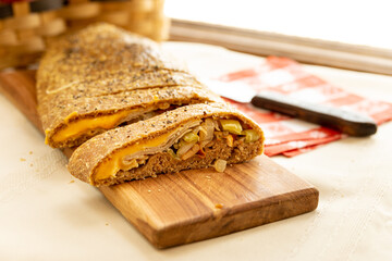 a loaf of Stromboli on a cutting board 