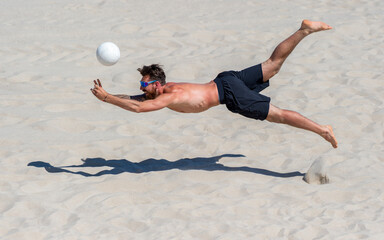Professional beach volleyball player in action, receiving the ball. Horizontal sport poster,...