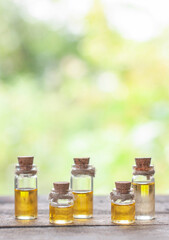 essential oil bottles in the nature blurred background with copy space