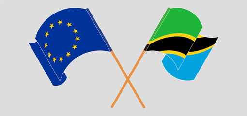 Crossed and waving flags of the EU and Tanzania