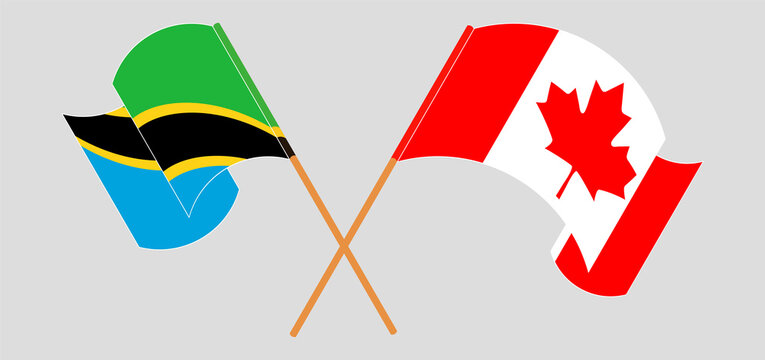 Crossed and waving flags of Tanzania and Canada
