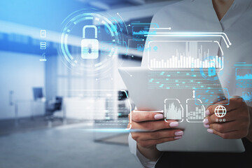 Businesswoman hand holds tablet device, blue hologram glowing digital information security interface. Concept of cyber security and data storage. Padlock and business symbols.