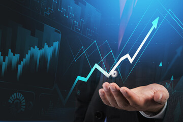 Businessman hand hold hologram blue arrow, trading and analyzing stock data to apply new strategy to beat the market.