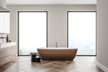 Modern bathroom interior with wood and stone decor elements and big window. Concept of contemporary design and spa relaxation.