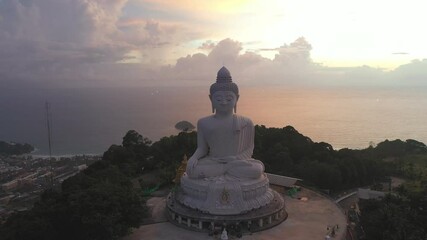 aerial view scenery sunset with rain clouds moving summer..beautiful silhouette Phuket big Buddha on hilltop..Another incentive to attract tourists to visit. 4k video for travel and worship concept