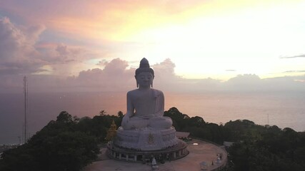 aerial view scenery sunset with rain clouds moving summer..beautiful silhouette Phuket big Buddha on hilltop..Another incentive to attract tourists to visit. 4k video for travel and worship concept