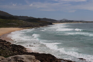 Obraz premium Image of a Galician beach with waves and rocks, in Castros de Baroña, La Coruña, Galicia, Spain.