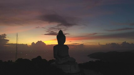 .aerial view scenery silhouette of Phuket big Buddha colorful sky in twilight background..Another incentive to attract tourists to visit. 4k video for travel and worship concept..