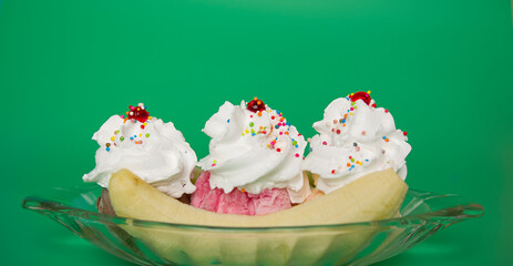 Topping Whip cream on top chocolate strawberry vanilla flavor ice cream Banana Split on green...