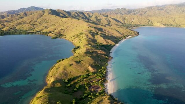North Komodo Island Indonesia with Loho Gebah peninsula with flat sandy beach , Aerial tilt up panorama shot