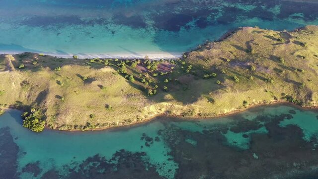 Loho Gebah flat beach and peninsula in north Komodo Island Indonesia, Aerial top view pan right shot