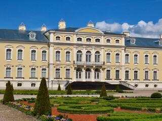 Fototapeta na wymiar Rundale in Latvia: yellow and white Baroque style palace built for Dukes of Courland by Bartolomeo Rastrelli, view from French gardens, sunny spring day