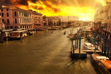 Naklejka premium Sunset aerial view of Canal Grande from Rialto Bridge the main and biggest bridge of Venice city of Italy in Veneto region. Italian UNESCO heritage.