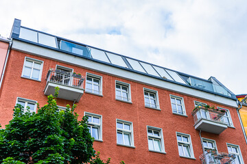 red apartment house with big windows on the roof