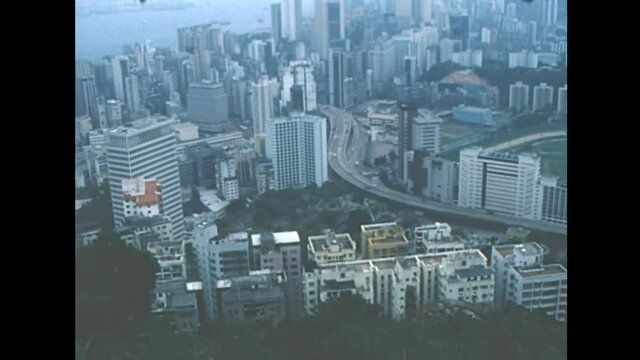 Aerial view of Victoria Harbour skyline from Mount Cameron overlook on top of Aberdeen Country Park in Hong Kong, China. Historic archival in 1987 with old port and vintage skyscrapers buildings.