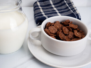 Cocholate cereal with milk on a white bowl
