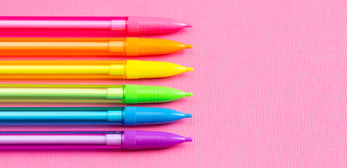 Background with Rainbow Mechanical Pencils on a Bright Pink Table Great for Back to School