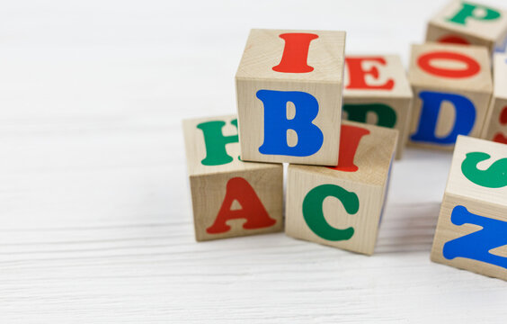 Wooden blocks spell out ABC on wooden table.  Games and tools for kids in preschool or daycare. Education, back to school concept