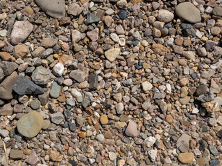 River pebbles close-up. Pebble beach texture, background for wallpaper.