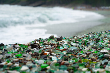 coastal strip of emerald glass pebbles and clear water