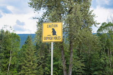 A warning sign of the gopher holes.   Wells Gray BC Canada
