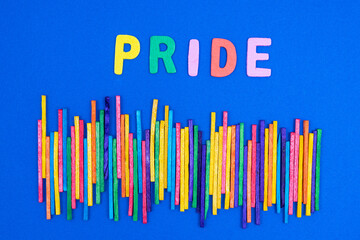 Pride movement colors. Some multicolored sticks on a blue surface	