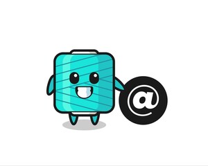 Cartoon Illustration of yarn spool standing beside the At symbol