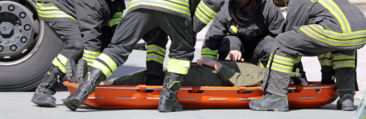 rescuers recover the injured with a special orange stretcher to transport the injured
