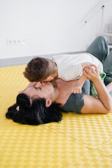 Rehabilitation of child with cerebral palsy in special center. Mother doing physical exercises and happily playing with boy, Sport activities for disabled kid. Inclusion and mobility Real people life