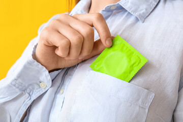 Woman putting condom into pocket, closeup