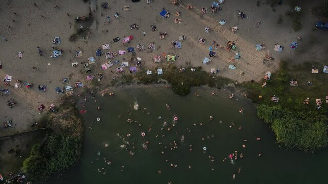 drone movement along a beach full of people