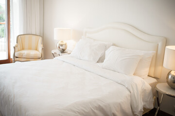 Fototapeta na wymiar big white bed with pillows