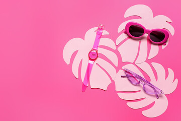 Composition with stylish sunglasses, wrist watch and paper palm leaves on color background