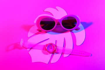 Composition with stylish sunglasses and wrist watch on color background