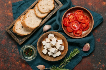 Composition with delicious pieces of feta cheese on grunge background