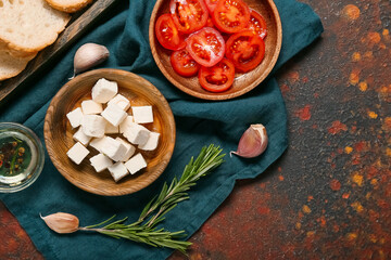 Composition with delicious pieces of feta cheese on grunge background