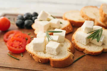 Sandwiches with feta cheese on wooden background