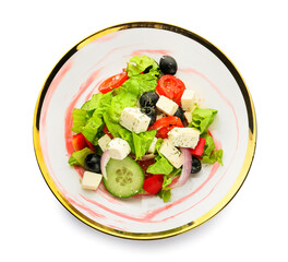 Plate with fresh Greek salad on white background
