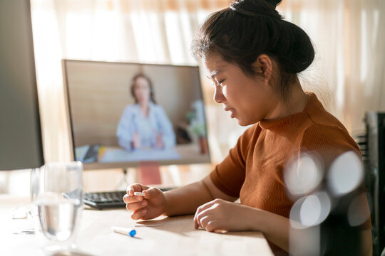 asian female hand nasal swab testing rapid tests by herself for detection of the SARS co-2 virus by tele video doctor instruction at home, isolate quarantine concept - Powered by Adobe