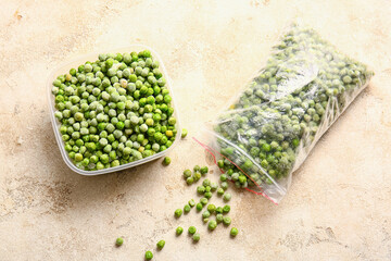 Container and bag with frozen green peas on light background