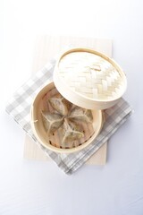 steamed handmade crystal vegetable prawn dumpling in bamboo basket white background dim sum Halal menu
