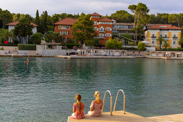 Fototapeta na wymiar Girls on a beach in Mali Lošinj, Croatia