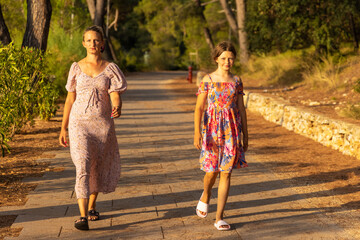 Mother and daughter are walking  on the path, Mali Losinj, Croatia
