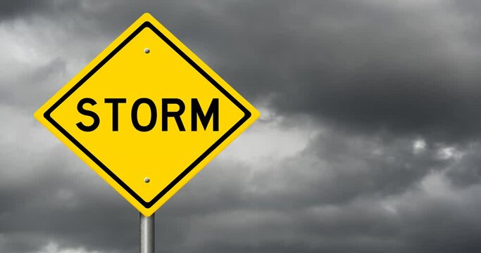 Yellow sign STORM with time lapse of dark storm clouds