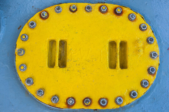 Iron, Yellow Ship Ballast Tank Cap On Gray Deck. Fuel Tank On Top.