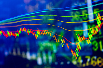 Abstract financial trading graphs and digital number of foreign exchange market trading on monitor. Background of gold and blue digital chart to represent stock market trend.